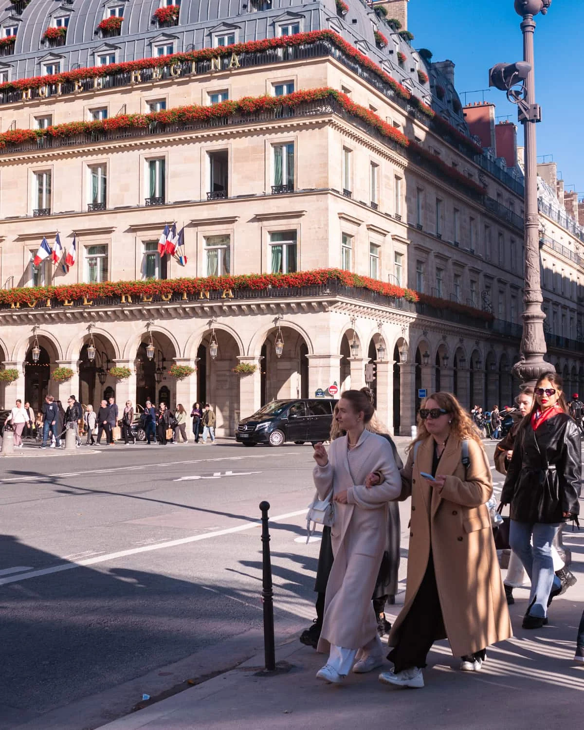 People walking on Rue Rivoli on a sunny Paris dat