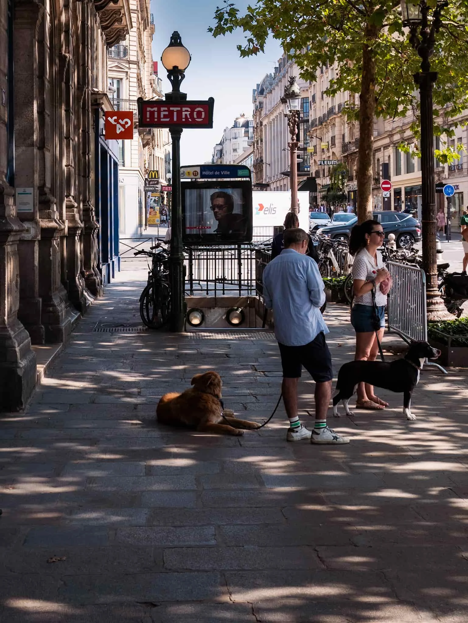 Paris tourists standing outside Paris metro entrance