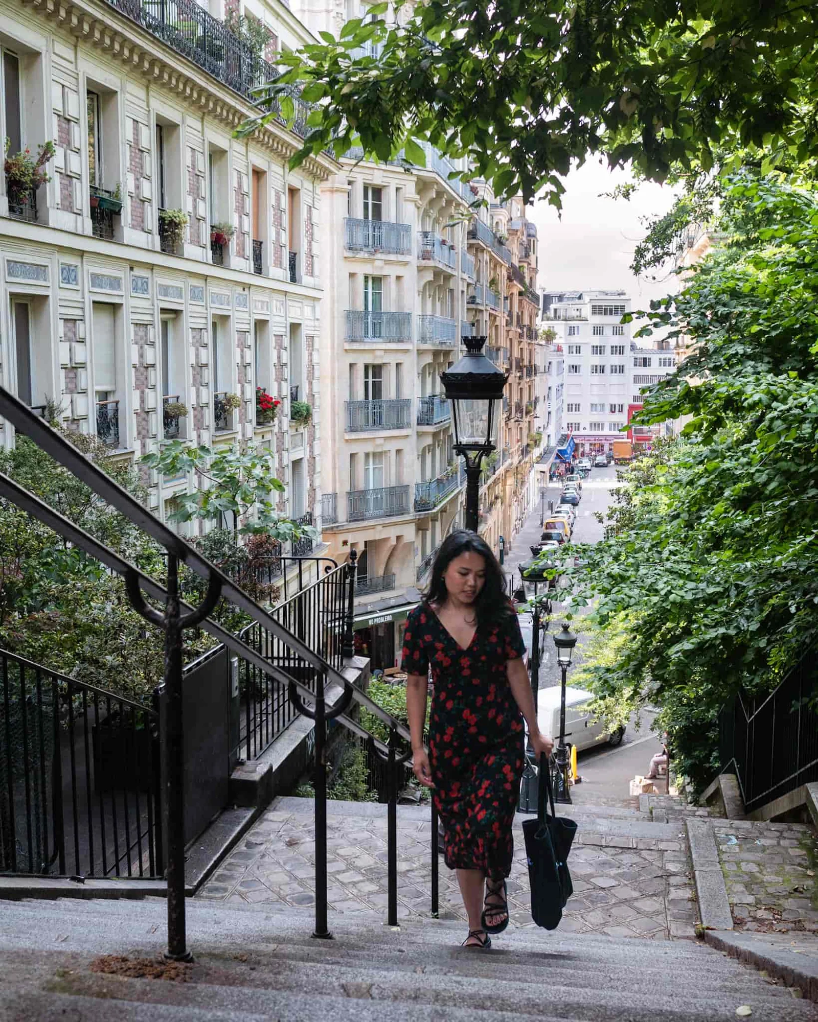 Parisian girl walking the steps in Montmartre Paris