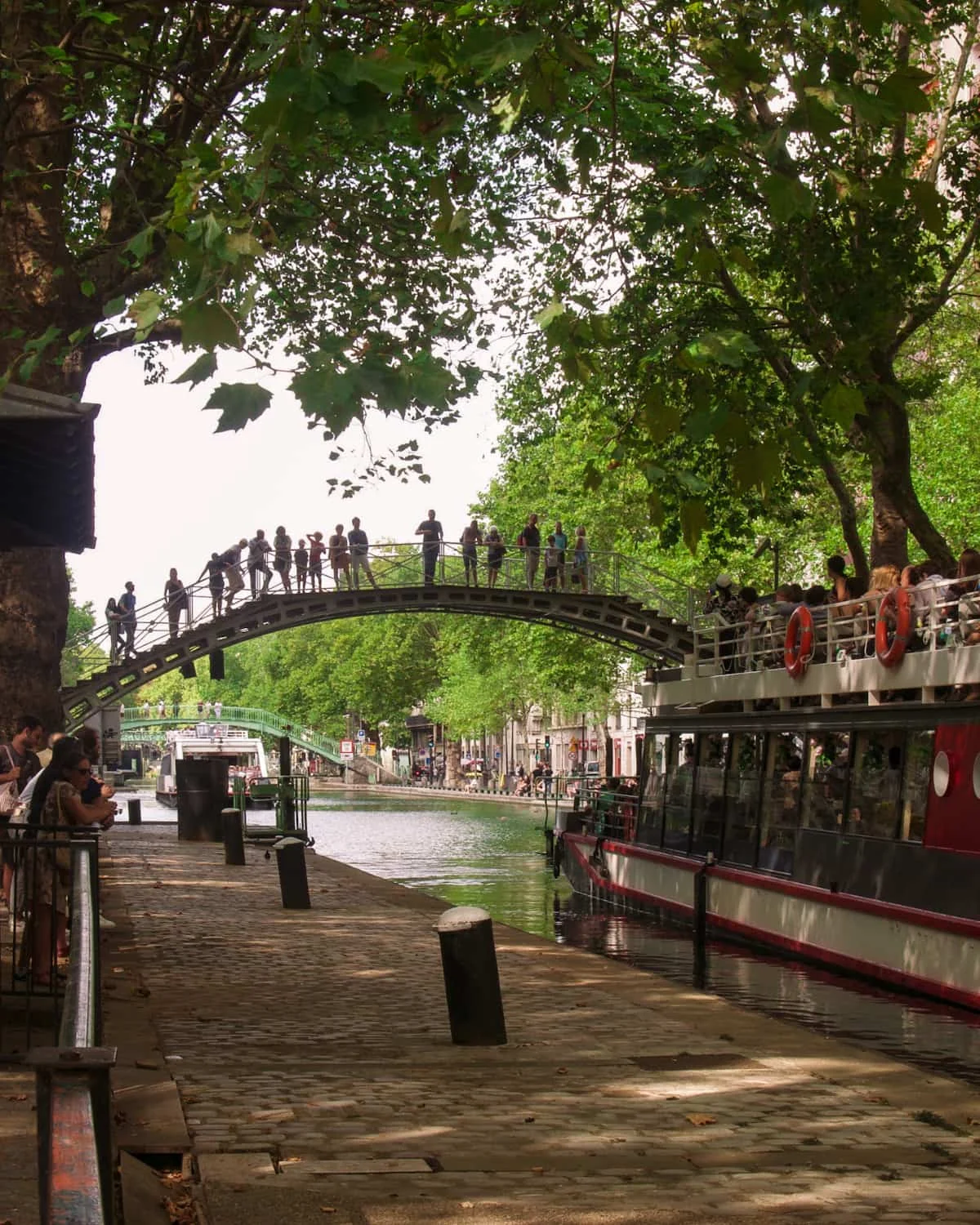 People watching cruise ships at Canal Saint Martin