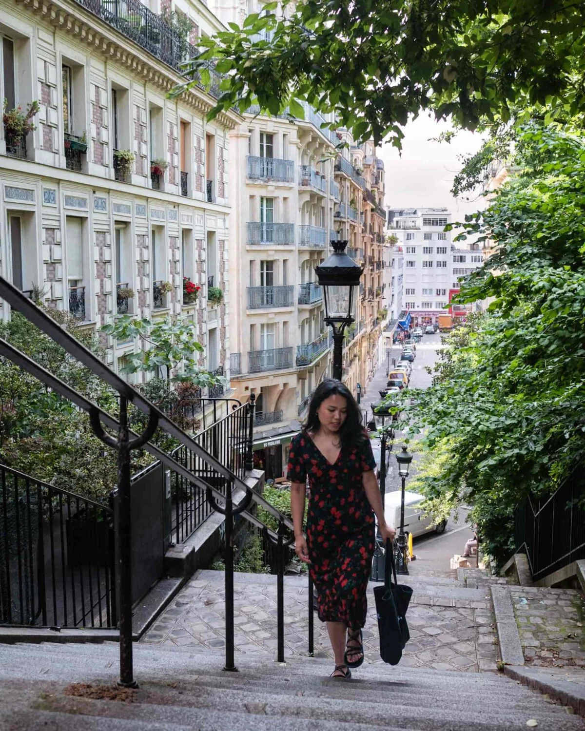Parisian girl walking the steps in Montmartre Paris
