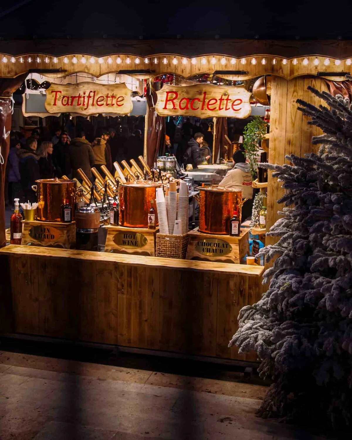 A stall at a christmas market selling tartiflette, raclette etc.