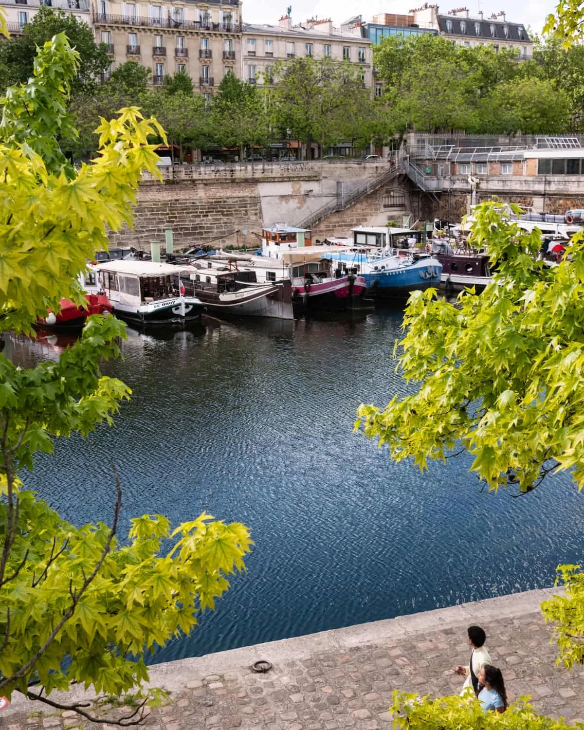 Boats at the Port de l'Arsenal, Paris with a view of Paris buildings