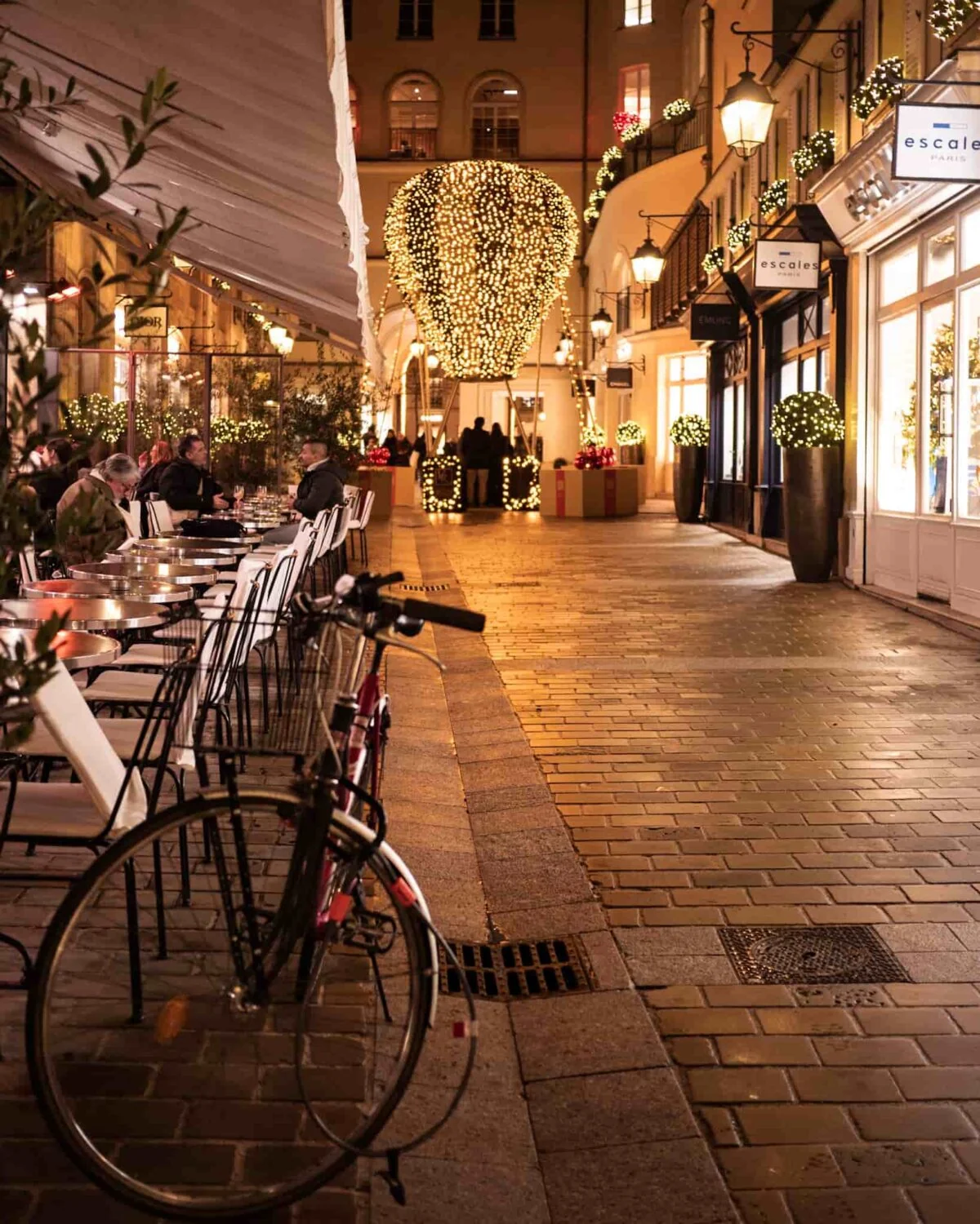 A view of a bike with a giant hot air balloon Christmas decoration in the background