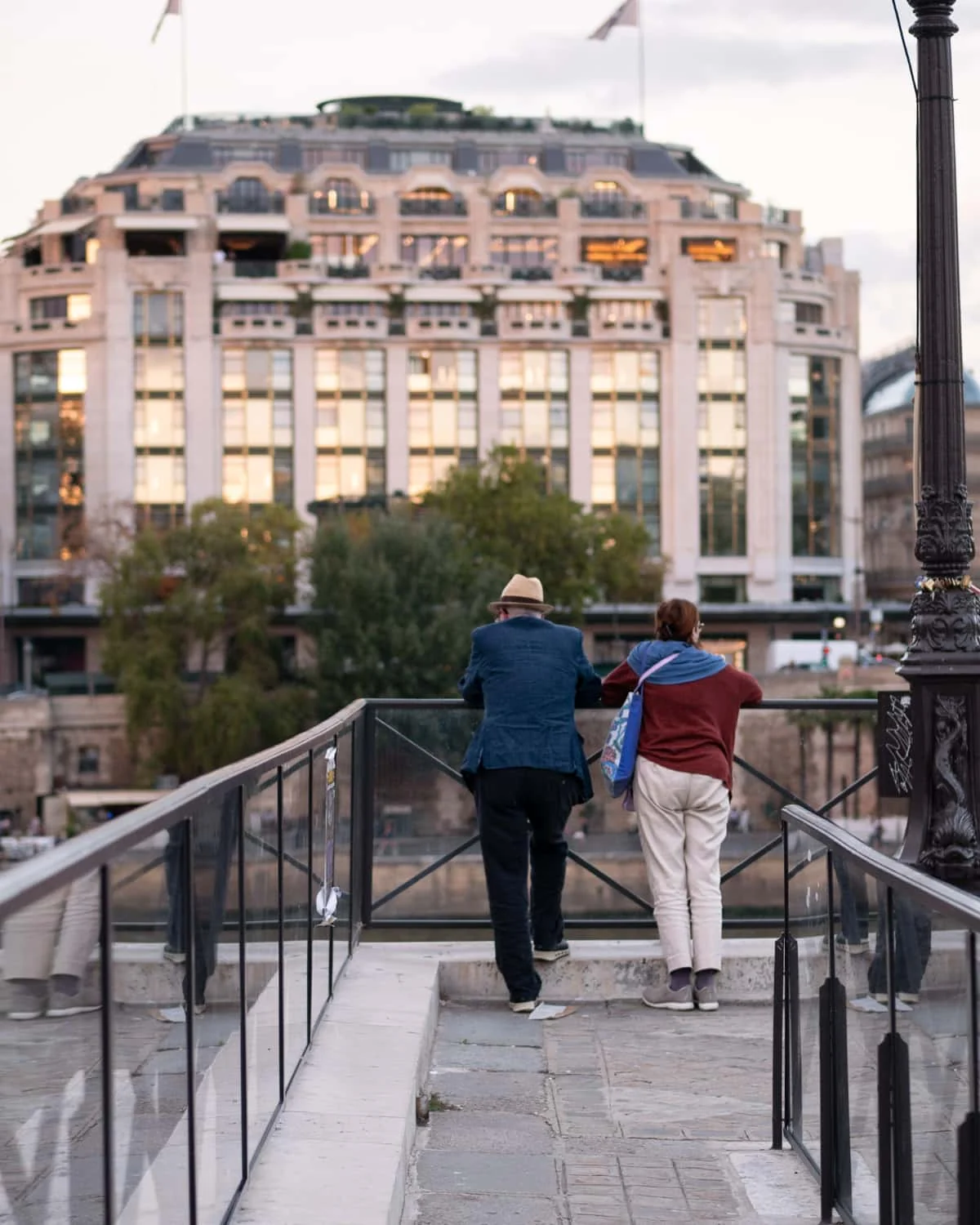 A couple looking out at the sunset from Île de la Cité Paris
