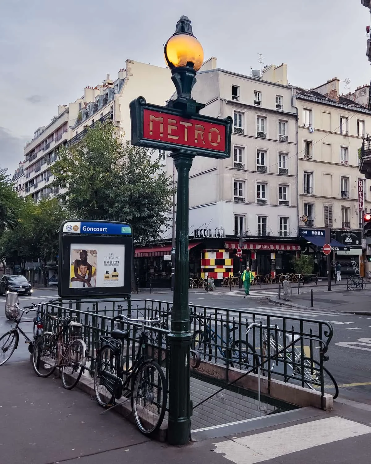 the entrance of Paris metro station with a view of Paris city