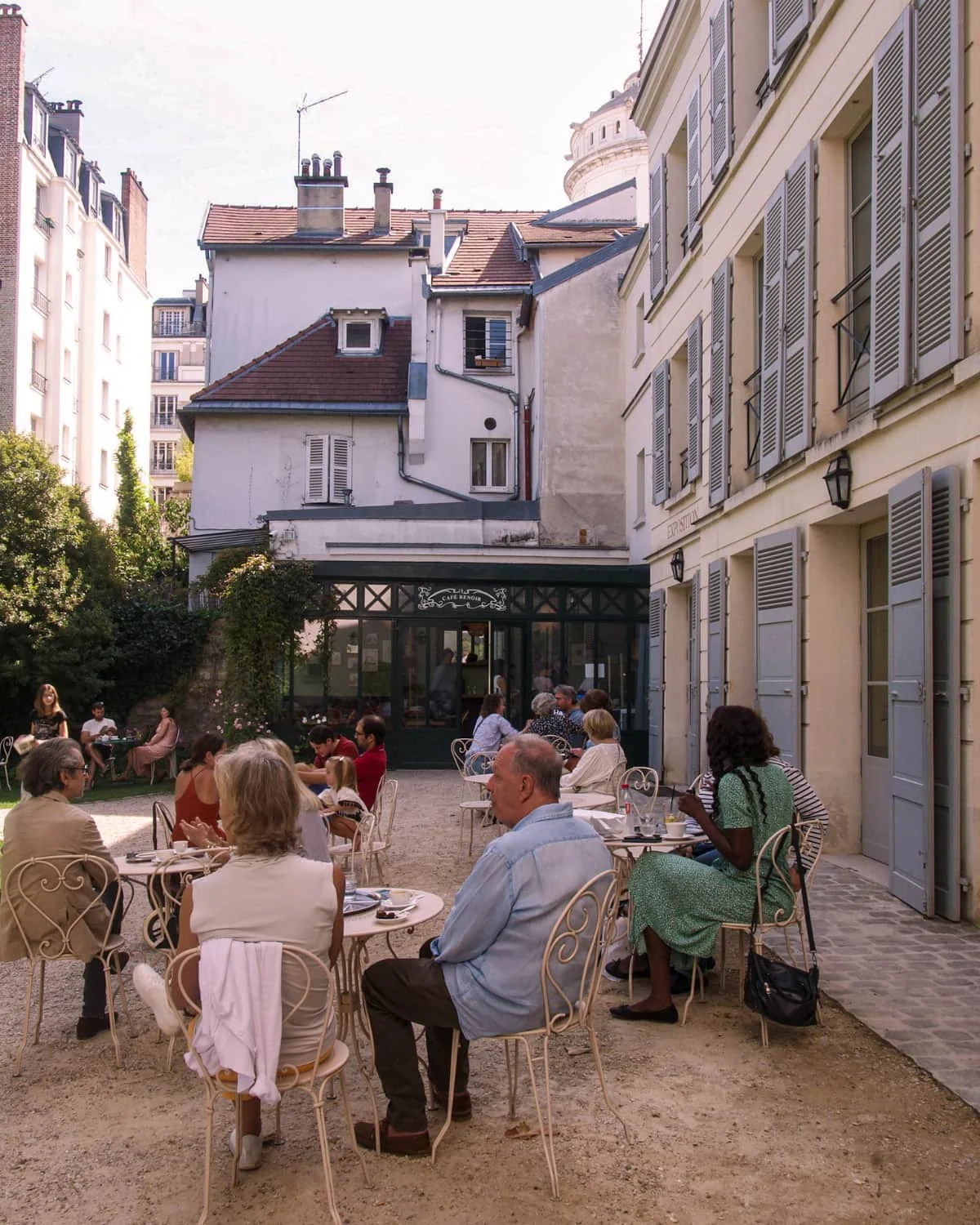 People sitting on terrace at Le Café Renoir at museum of Montmartre