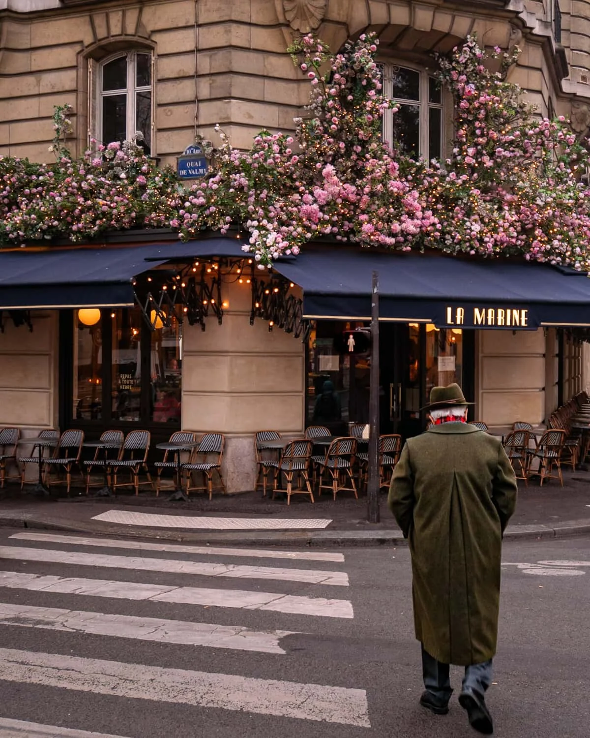 Parisian man in stylish overcoat walking to a café