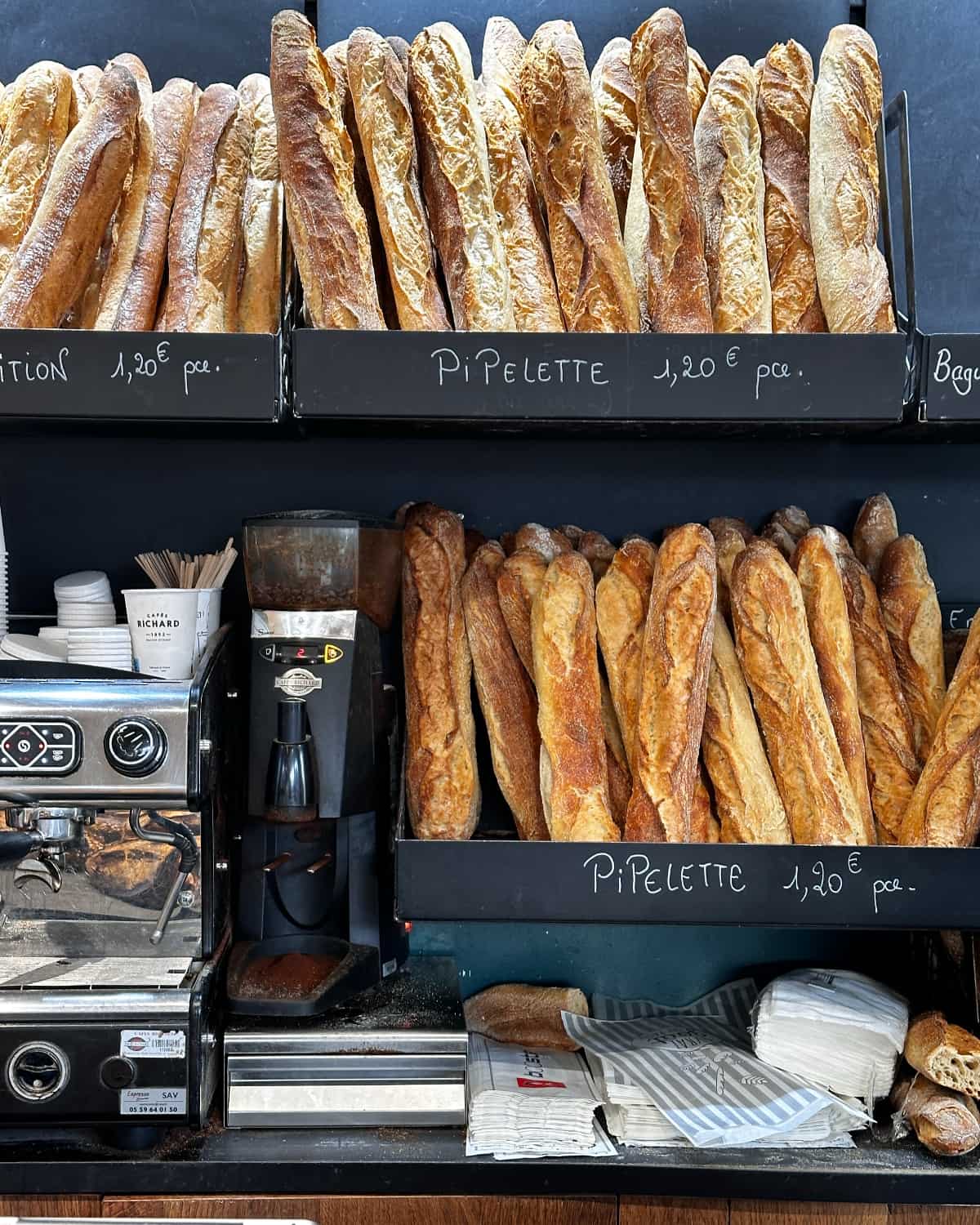 Baguettes displayed on the shelves of a French bakery