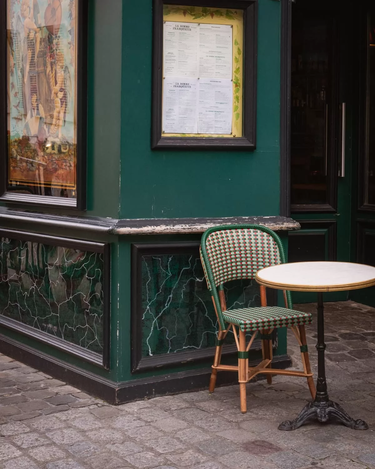 Green table and chair at a Paris restaurant
