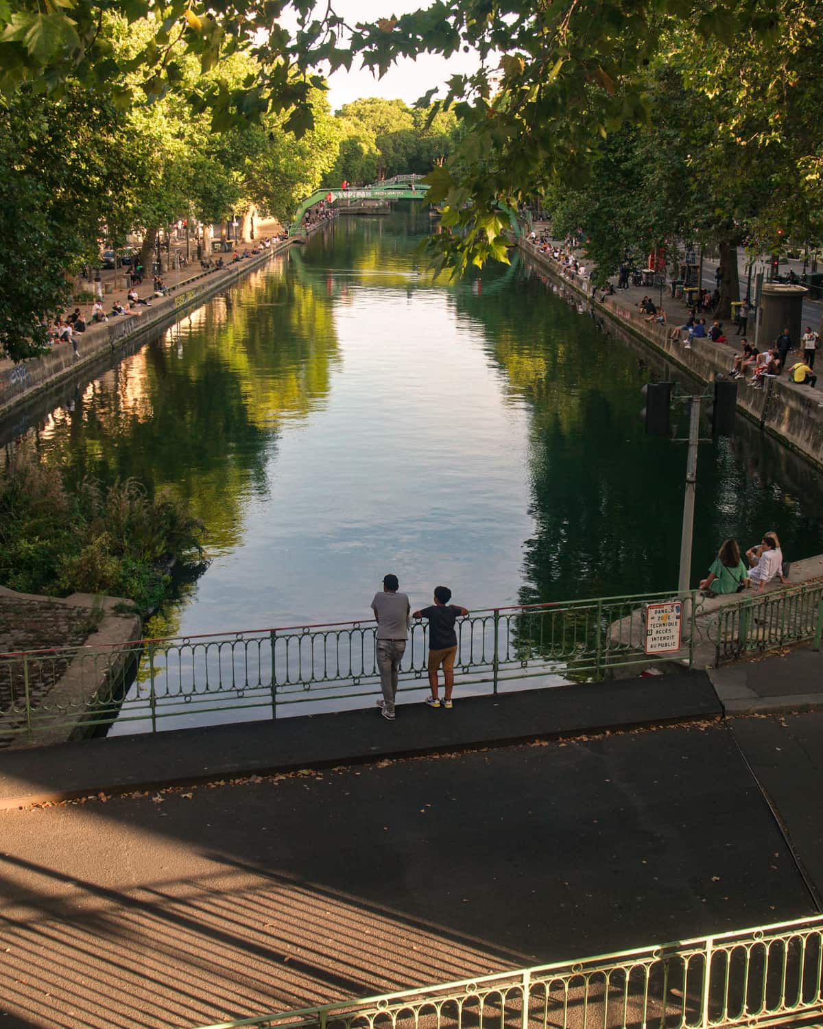 A father and son enjoying the sight at Canal Saint Martin, Paris